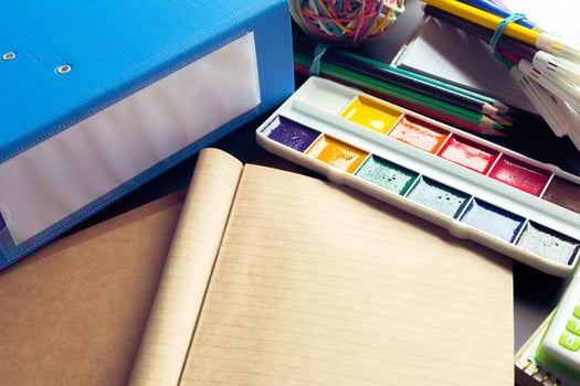 Desk of an artist with lots of stationery objects photo