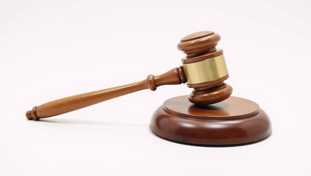 Wooden judges gavel on a plain backdrop embodies power fairness and legal principles photo