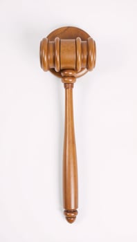 Wooden judges gavel on a plain backdrop embodies power fairness and legal principles photo