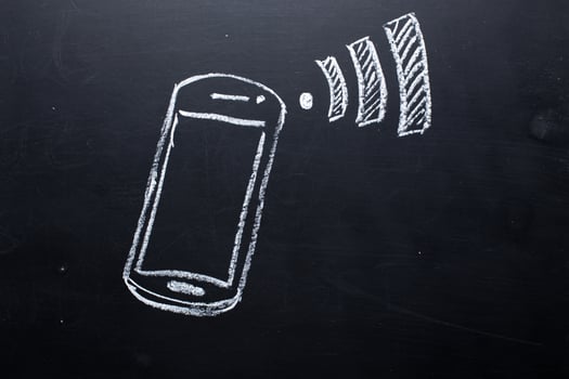 Wireless Symbol Drawn on a Blackboard near smartphone photo