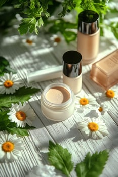 Cosmetics arranged on a wooden surface with daisies and green foliage in natural light photo