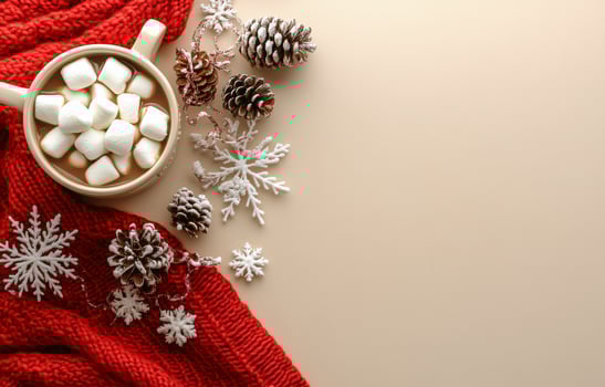 Cozy winter hot chocolate with marshmallows and pine cones on a red knitted blanket photo