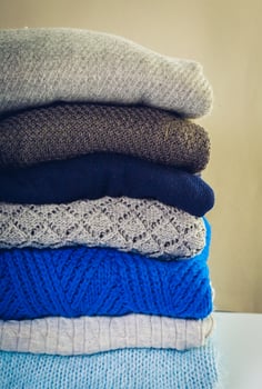 Stack of cozy knitted sweaters photo
