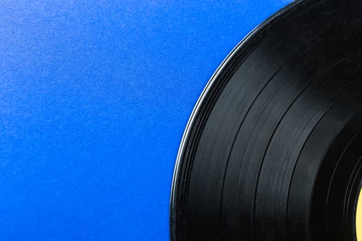 Retro vinyl record on blue background photo