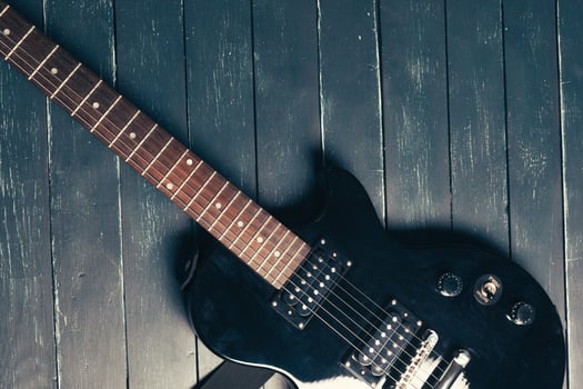 Electric guitar body and neck detail on wooden background photo