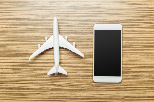 Preparation for Traveling concept. Smartphone, airplane photo