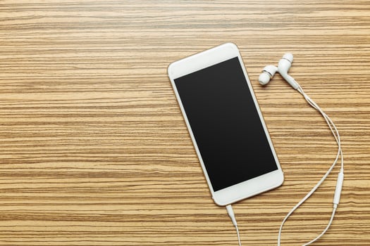 Office table with smartphone on it. View from above photo