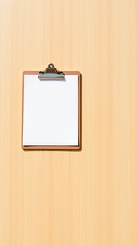 blank clipboard on wooden surface photo