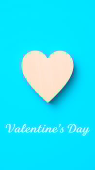 light wood heart on a bright blue background photo