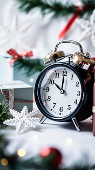 black alarm clock with silver accents amidst festive decorations photo