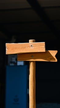 weathered wooden signpost with two directional arrows photo