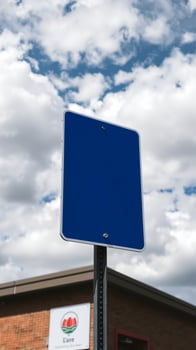 blank blue sign with a white border against a cloudy sky photo
