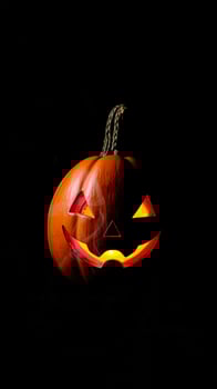 carved pumpkin glowing with a candle inside photo