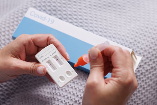 woman tests herself for new strain of coronavirus at home, covid-19 and flu virus test photo