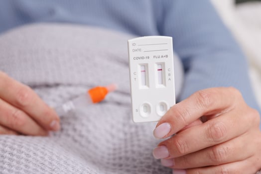 woman tests herself for new strain of coronavirus at home, covid-19 and flu virus test photo
