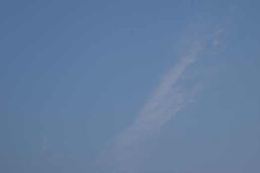 a clear blue sky with some clouds in it photo