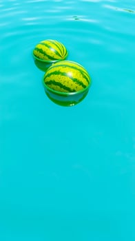 two watermelons float a turquoise pool photo