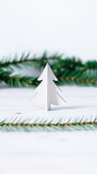 white paper tree cutout with pine branches photo