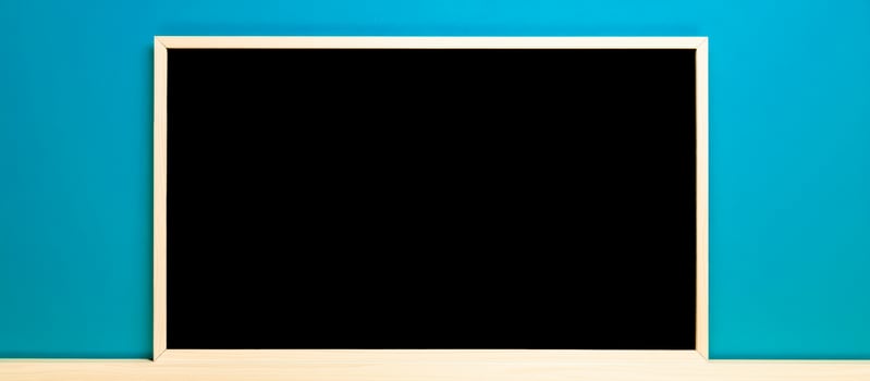 black board against a blue wall photo