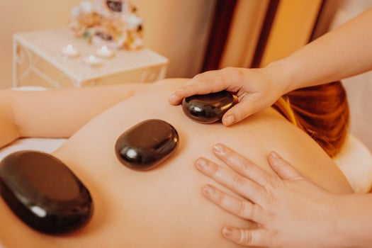 Top view of happy masseur massaging young woman back on a massage table, concept of massage spa treatments, healthy lifestyle photo