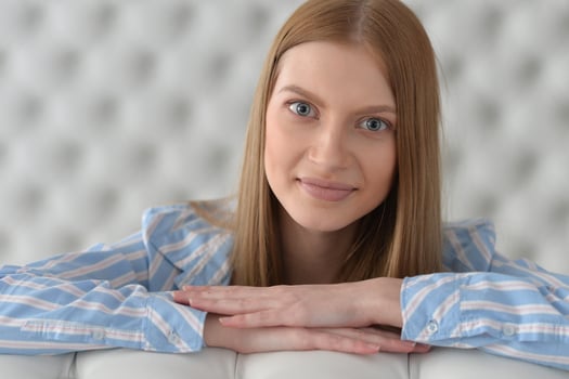 Beauty portrait. Young woman on grey wall background. photo