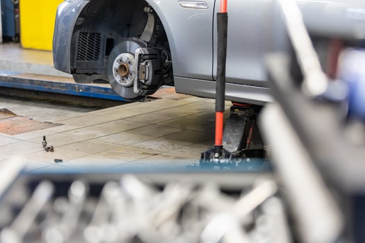 Car service center concept, vehicle raised on lift at maintenance station, auomobile repair, check up, repairing the car photo
