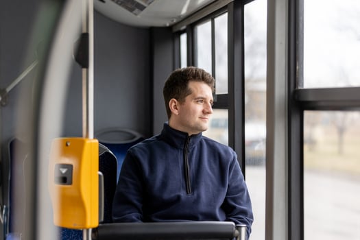 Male bus passenger in the public bus transport, concept of an urban transportation photo