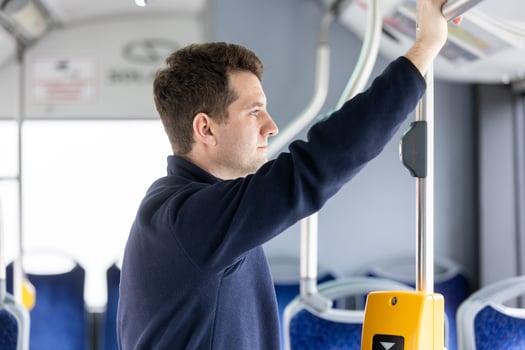Male bus passenger in a public bus transport, concept of an urban transportation photo