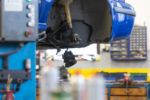 Car service center concept, vehicle raised on lift at maintenance station, auomobile repair, check up, repairing the car photo