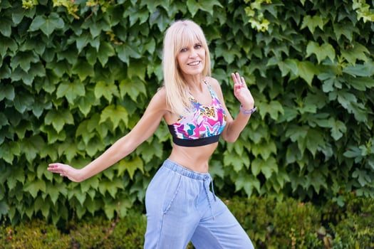 Dancer expressing movement through dance next to an urban garden photo