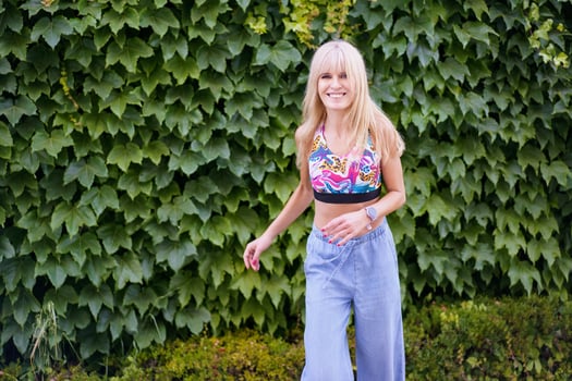 Happy dancer smiling while dancing next to an urban garden photo