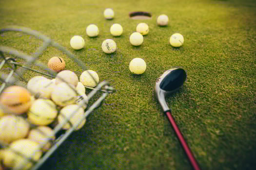 Close up of golf club and balls by the hole on the grass yard, sport concept photo