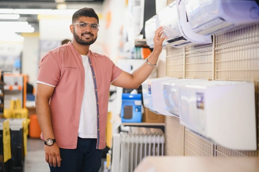 An Indian man is choosing a new air conditioner in an electronics store photo