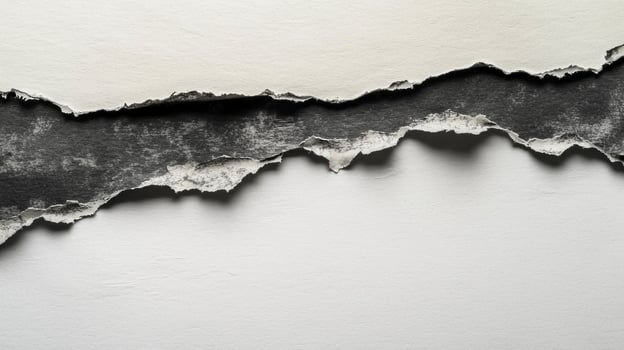 rip in a sheet of paper exposes a contrasting dark surface underneath featuring intricate highly detailed torn edges that create an artistic backdrop. photo