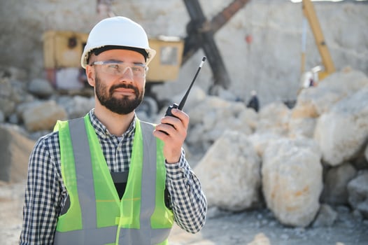 Male worker with bulldozer in sand quarry photo