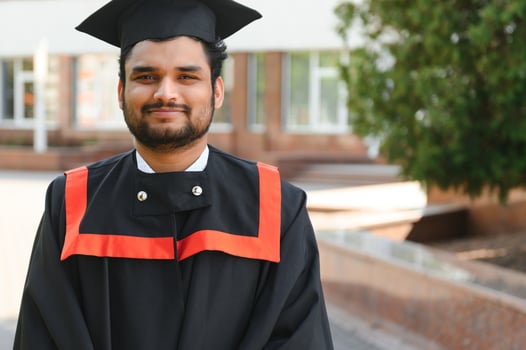 education, graduation and people concept - happy Indian Male graduate student photo