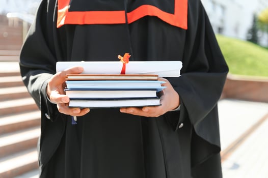 Close up people graduating with diplomas photo