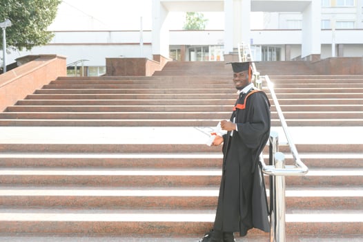 Happy graduate. Happy African man in graduation gowns photo