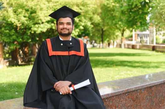 education, graduation and people concept - happy Indian Male graduate student photo