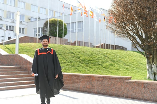 education, graduation and people concept - happy Indian Male graduate student photo