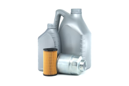 Automotive oil container and filters isolated on white background with focus on maintenance supplies photo