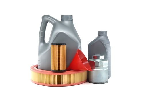 Variety of automotive maintenance essentials including oil jugs, air filter and funnel photo