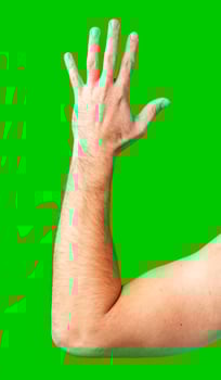 human arm gesturing with raised fingers against a bright green backdrop photo