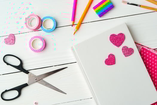 Crafting a colorful workspace with decorations, stationery, and artistic tools on a clean wooden surface photo