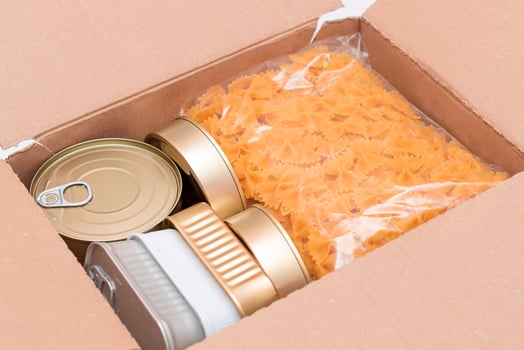 Food Reserves or Donation Box. Carton Box with Canned Food, Cereals and Grocery. Emergency Food Storage in Case of Crisis. Free Social Help, Blessings and Care. Strategic Food Supplies photo