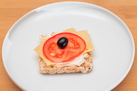 Rice Cake Sandwich with Tomato, Cheese and Olives on White Plate. Easy Breakfast. Diet Food. Quick and Healthy Sandwiches. Crispbread with Tasty Filling. Healthy Dietary Snack photo