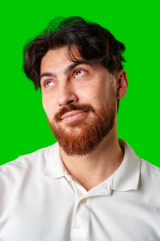 A man with a beard smiles confidently against a bright green background photo