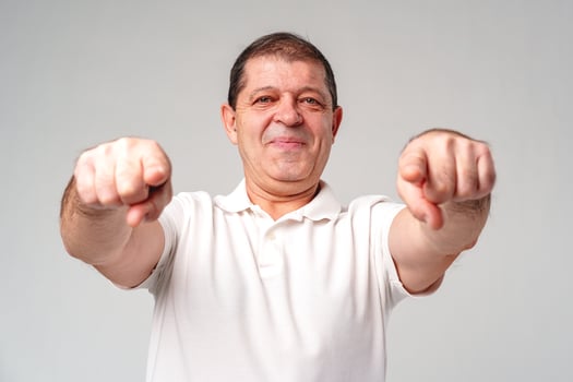 An older man smiling and reaching out with both hands photo