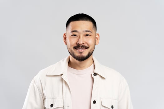 Happy young asian man smiling on white background photo