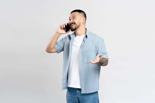 Young man having phone conversation gesturing with hand photo